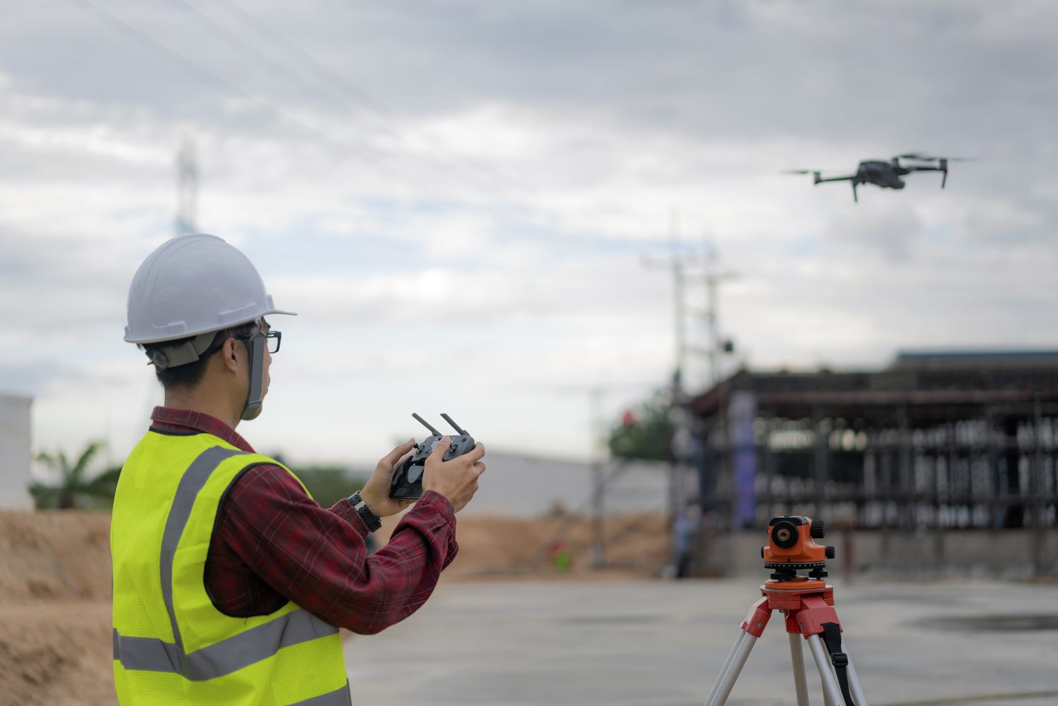 asian-construction-worker-piloting-drone-at-building-site–video-surveillance-or-industrial-inspection-1134482179-0eaae7a705fa4813ba24af65729368e6